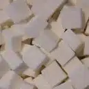 a pile of white sugar cubes sitting on top of a table