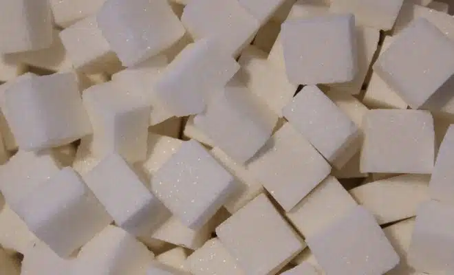 a pile of white sugar cubes sitting on top of a table