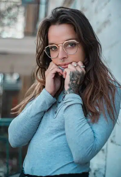 woman in blue sweater wearing eyeglasses