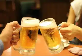two mugs of brown liquids